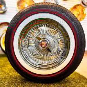 15x7” Chrome 100 Spoke Wire Wheels + 215/70R15 Vogue Red Stripe Tires | Cadillac Wire Wheel Set - front view with 2-bar