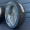 26” Chrome Dayton-Style Wire Wheels – Staggered Donk Set (8” Lip Rear) + 275/25R26 Custom Blue Stripe Tires | Set of 4