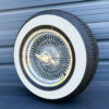 15x7-standard-chrome-wire-wheels-100-spoke-with-215-70-15-with-three-inch-whitewall-tires-side-view 2.5" thick whitewall mounted on 15x7 wire wheel with 2-bar knock-off