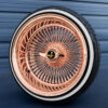 17x9-reverse-rose-gold-100-spoke-wire-wheels-with-205-45-17-custom-true-whitewall-tires-black-and-gold-eagle-chip 17x9 rose gold wire wheel reverse with 2-bar knock-off and black eagle metal chip
