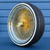 22-inch-standard-wire-wheels-gold-center-255-30-r22-custom-whitewall-tires-side-view-2 Gold center wire wheels mounted on a whitewall tire