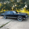 Chrome 96-spoke wire wheel with 2-Bar Eagle center on 1990 Chevrolet Caprice