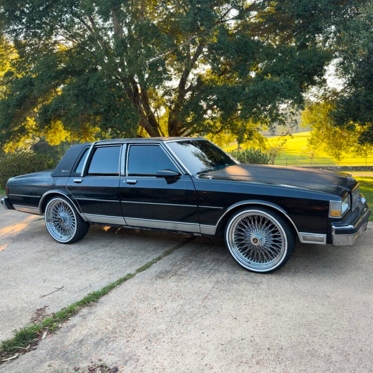 Chrome 96-spoke wire wheel with 2-Bar Eagle center on 1990 Chevrolet Caprice