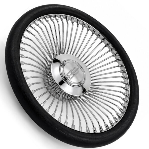 oldsmobile-chrome-spoke-steering-wheel-black-grip-angle-view Angled view of Oldsmobile 64-spoke chrome wire steering wheel showing polished chrome spokes and engraved emblem